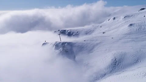 Snowy mountain valley with clouds. High altitude ski gondola in winter. 스톡 동영상 150679967