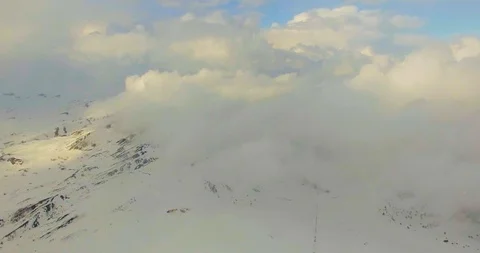 Snowy Mountain View Over The Clouds at Sunset Drone Shot Stock Footage 118935858