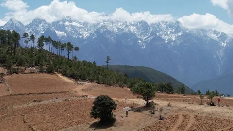 Snowy Mountain Wall Above Forest Valley in Shangri La Yunnan China Stock Footage 337759680
