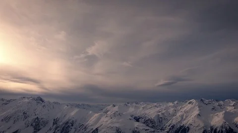 Snowy mountains and clouds time lapse with yellow warm sunlight and cool blue Stock Footage 85430461