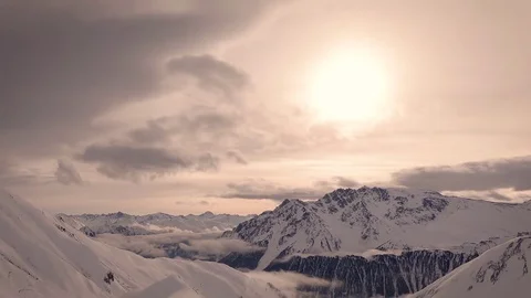 Snowy mountains and clouds time lapse with with yellow orange and red warm Video stock 85431832