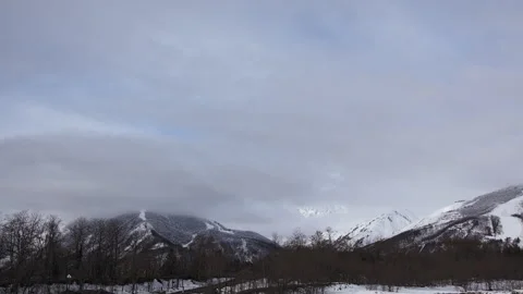 Snowy Mountains and Clouds: A Time-Lapse of Morning Mist in a Winter Landscape Stock Footage 333133945