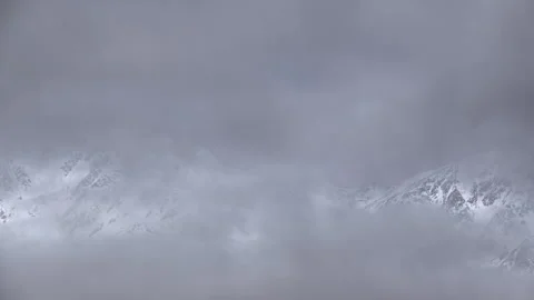 Snowy Mountains and Clouds: A Time-Lapse of Morning Mist in a Winter Landscape Stock Footage 333133965