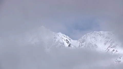 Snowy Mountains and Clouds: A Time-Lapse of Morning Mist in a Winter Landscape Stock Footage 333133978