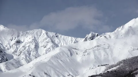 Snowy Mountains and Clouds: A Time-Lapse of Morning Mist in a Winter Landscape Stock Footage 333134078
