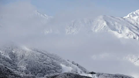 Snowy Mountains and Clouds: A Time-Lapse of Morning Mist in a Winter Landscape Stock Footage 333134153