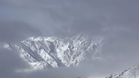Snowy Mountains and Clouds: A Time-Lapse of Morning Mist in a Winter Landscape Stock Footage 333134202