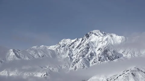 Snowy Mountains and Clouds: A Time-Lapse of Morning Mist in a Winter Landscape Stock Footage 333134307