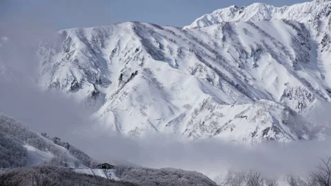 Snowy Mountains and Clouds: A Time-Lapse of Morning Mist in a Winter Landscape Stock Footage 333134428
