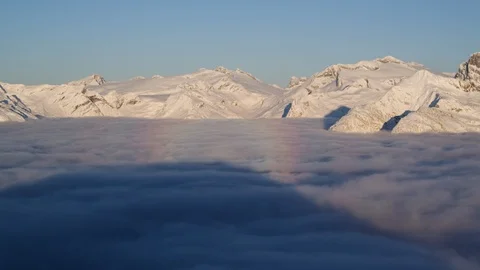 Snowy mountains and fluffy clouds during sunny day Stock Footage 116784221