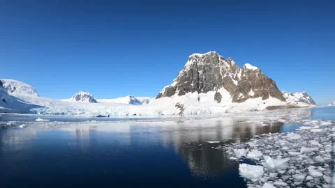 Snowy mountains on background of water surface in Antarctica time lapse. Stock Footage 231602453