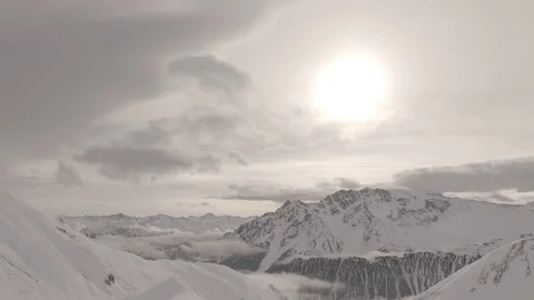 Snowy mountains clouds time lapse shot flat raw for post color grading. Samnau Stock Footage 85130221