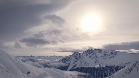 Snowy mountains clouds time lapse with yellow warm sunlight cool white cloud Stock Footage 85430787