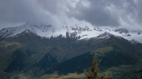 Snowy mountains covered in stormy clouds Stock Footage 196121887