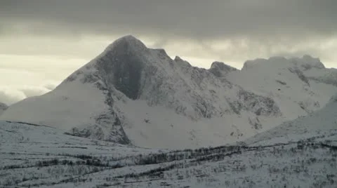 Snowy mountains with dark clouds Stock Footage 12136055