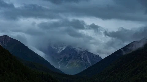 Snowy mountains inside the clouds Stock Footage 84001149