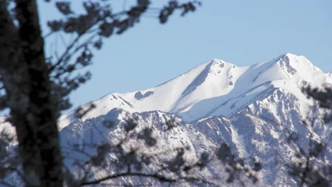 Snowy mountains of remaining and cherry blossom in the morning Stock-Footage 152540480