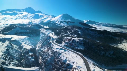 Snowy mountains roads pine forests and magnificent scenery 動画素材 294219782