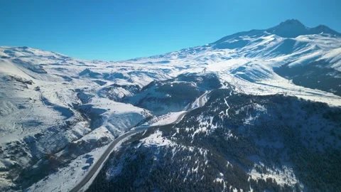 Snowy mountains roads pine forests and magnificent scenery 動画素材 294223309