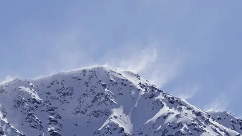 Snowy mountains with snow creating spirals in the air due to the wind Stock Footage 238627830