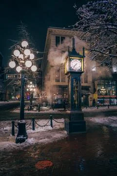 Snowy night at clock tower Stock Photos