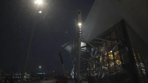 Snowy night frames theater illuminated by gentle lighting Stockbeeldmateriaal 326465336