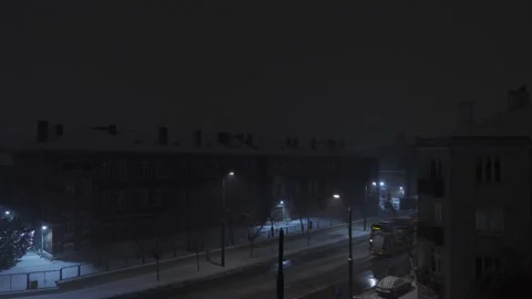 A snowy night with trams passing by Stock Footage 146869974