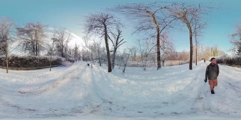 Snowy park with a walking man Stock Footage 264053555