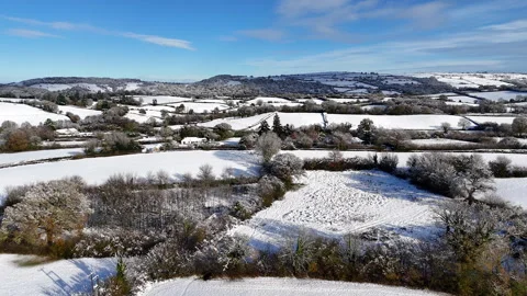 Snowy Patchwork Fields and Distant Hills. Stock Footage 345960469