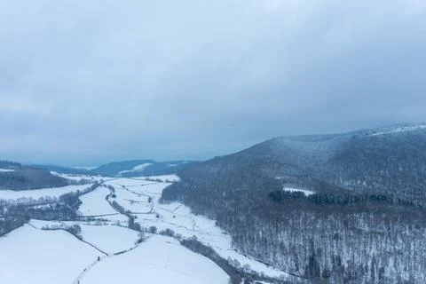 Snowy patchwork fields and wooded hills in Morvan 写真素材