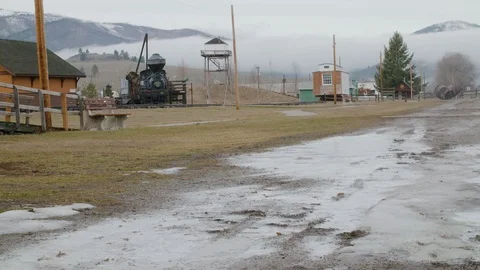Snowy path in front of Engine Number 7 and Drummond Depot at Fort Missoula Stock-Footage 90818857