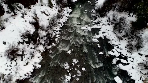 Snowy Payette River flying down stream drone 4k 動画素材 140034894