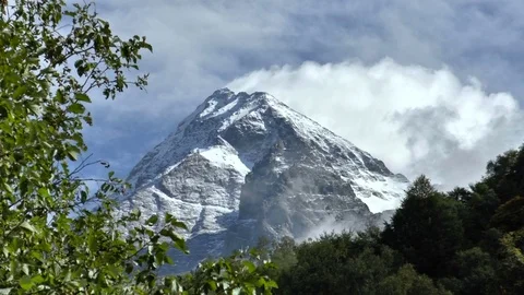 Snowy peaks in the clouds Stock Footage 70807451