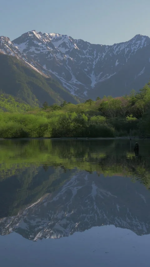Snowy Peaks Reflected in Taisho Pond Vertical Video 스톡 동영상 345994902