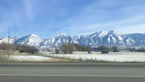 Snowy peaks on the side of a highway Stock Footage