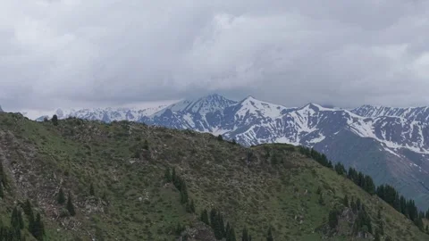 Snowy peaks under a cloudy sky in Almaty mountains Stock Footage 345387881