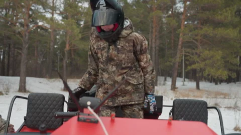 Snowy pine forest ATV scene. Caucasian motorcyclist getting ready in snow Video stock 345145450