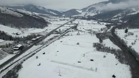 Snowy Road with Cars Moving Through the Winter Landscape Video stock 300508053