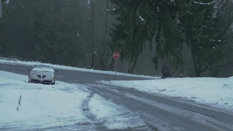 Snowy road close to forest. SUV going to intersection. Not graded. Stock-Footage 103058932