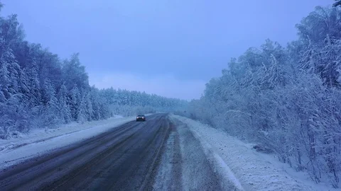 Snowy road in the middle of a forest on the Ural-Tau ridge Stock Footage 122928368