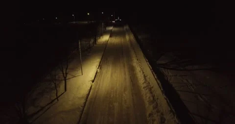 Snowy road at night 1 Stockbeeldmateriaal 332174082