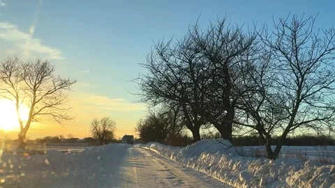 Snowy road at sunset with trees in winter landscape 스톡 동영상 331901395