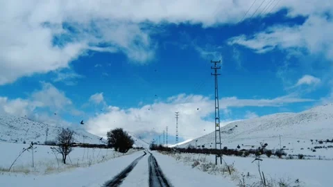 Snowy roads and partly clouds in the blue sky Stockbeeldmateriaal 199378426