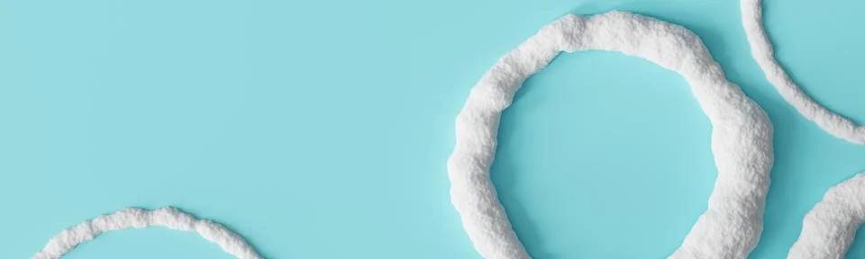 Snowy round frames are placed on a light blue background. The scene has amp.. Stock Photos