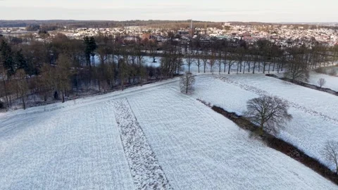 Snowy rural landscape with open fields scattered leafless trees and distant. Stock Footage 327981306