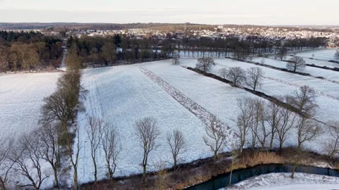 Snowy rural landscape with open fields scattered leafless trees and distant Video stock 327981589