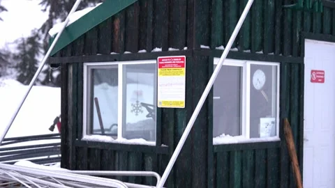 Snowy Ski Resort Scene with Equipment and Cabin Exterior Stock Footage 264496953