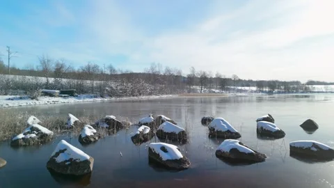 Snowy Teåkersjön lakeshore low angle aerial parallax Stock-Footage 327340425