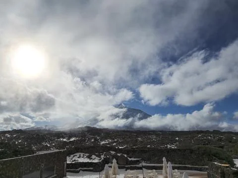 Snowy volcanic landscape with dramatic cloudy sky Stock Photos