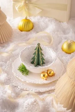 Snowy white Christmas table setup with snowy trimmings. Stock Photos